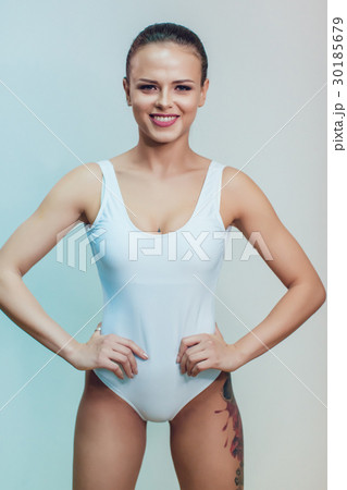 Beautiful sexy girl with tattoo in white bodysuit 30185679