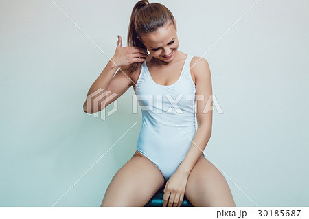 Beautiful sexy girl with tattoo in white bodysuit Beautiful sexy girl with tattoo in white bodysuit 30185687