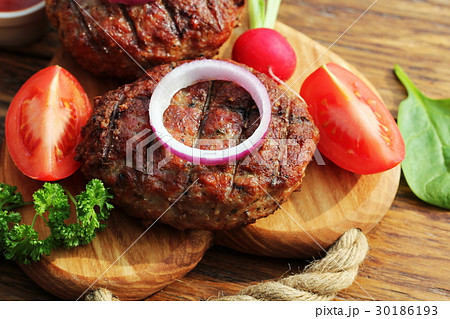 Homemade beef burger with onion on cutting board 30186193