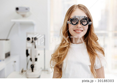 Beautiful teenage girl wearing trial glasses 30186303