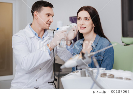 Smiling brunette turning her ear to expert 30187062