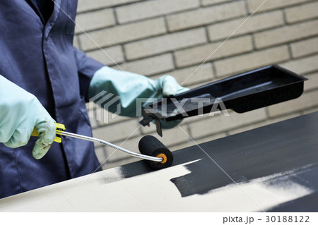 young man painting a wooden board 30188122