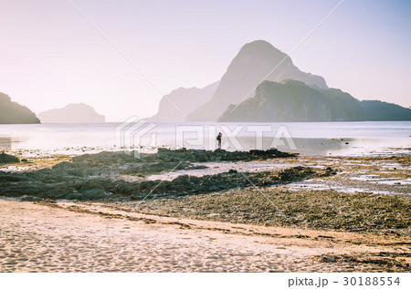 Lonely photographer on top of the rocks during low 30188554