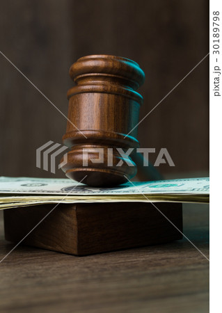Hammer on banknotes at table 30189798