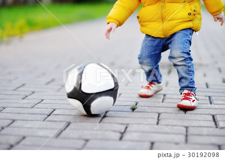 Little boy having fun playing a soccer game  30192098
