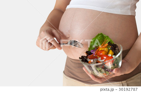 Pregnant woman's belly and vegetable salad Pregnant woman's belly and vegetable salad 30192787