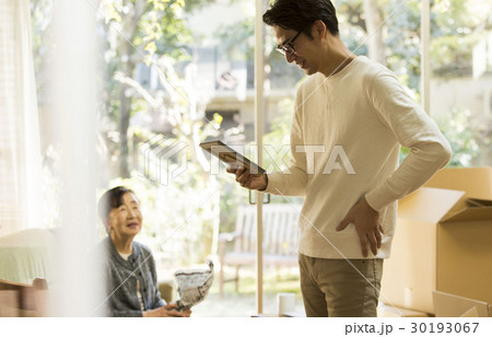 引っ越し作業　写真を見る男性 30193067