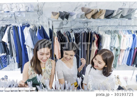 Young girls look very delighted while choosing clothes 30193725