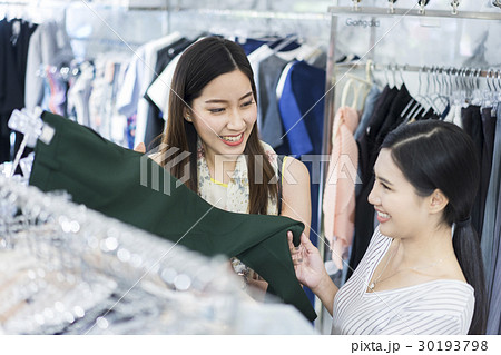 A woman is choosing pants. A woman is choosing pants. 30193798