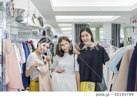 A group of women are trying clothes in the store. 30193799