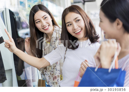 A group of women window shopping in shopping mall. 30193856
