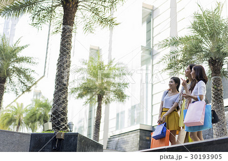 A group of cute girls beside colorful handbags. 30193905