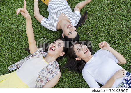 Lovely girl is poiting a bird for friends in the park. Lovely girl is poiting a bird for friends in the park. 30193967