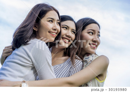 Portrait of three person are smiling and hugging together. 30193980