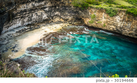 Small Sandy Beach in front iof Stone arch over the 30194666