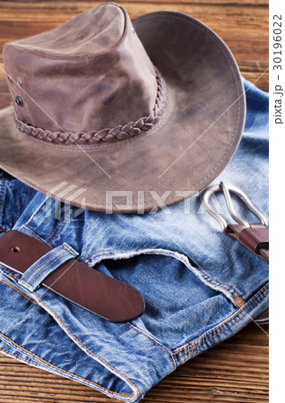 Jeans and leather hat on a wood board Jeans and leather hat on a wood board 30196022