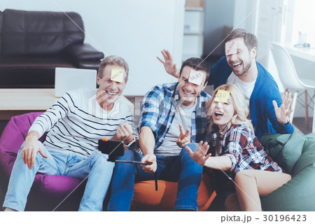 Positive relaxed colleagues making selfies Positive relaxed colleagues making selfies 30196423