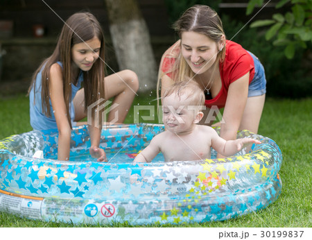 Baby swimming in outdoor pool with mother Baby swimming in outdoor pool with mother 30199837