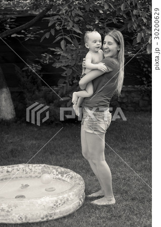 Image of mother hugging baby boy after swimming Image of mother hugging baby boy after swimming 30200629