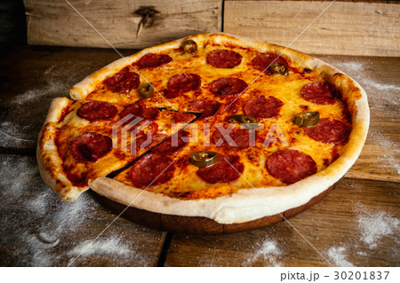 Whole pizza with sausages and pepper on wood Whole pizza with sausages and pepper on wood 30201837