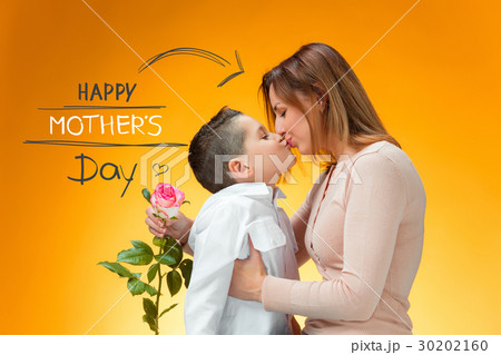 Young kid giving red rose to his mom 30202160