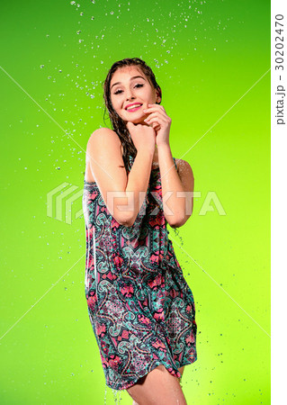 Young beautiful woman under splash of rain 30202470