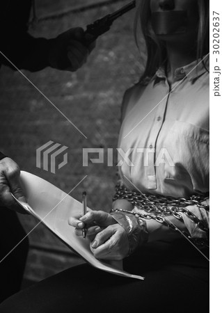 Desperate businesswoman signing the contract under Desperate businesswoman signing the contract under 30202637