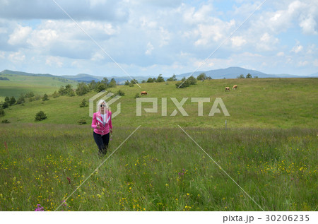 Woman Running over Hills on Cloudy Day Woman Running over Hills on Cloudy Day 30206235