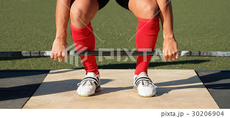 Man practicing weight lifting out on the pitch 30206904