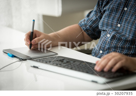 Man using digital graphic tablet and keyboard Man using digital graphic tablet and keyboard 30207935