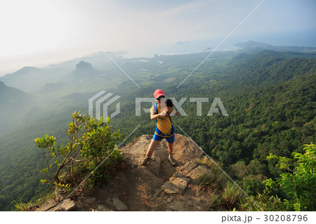 woman hiker taking photo with cellphone  30208796