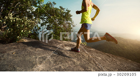 woman trail runner running at mountain top woman trail runner running at mountain top 30209105