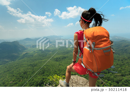 successful woman hiker hiking on mountain peak successful woman hiker hiking on mountain peak 30211418