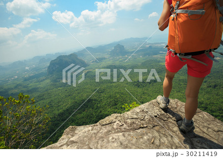 young woman backpacker hiking at mountain top 30211419