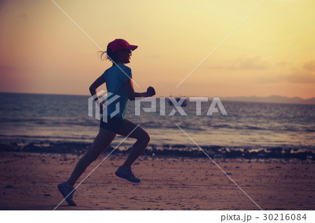 young fitness woman running at morning beach 30216084