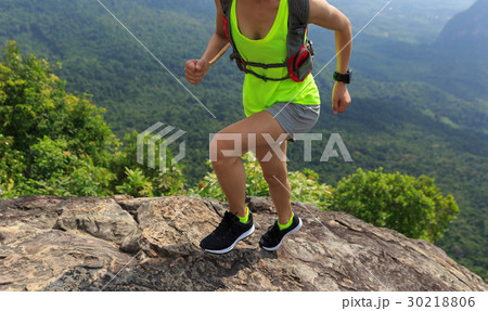 woman trail runner running at mountain top 30218806