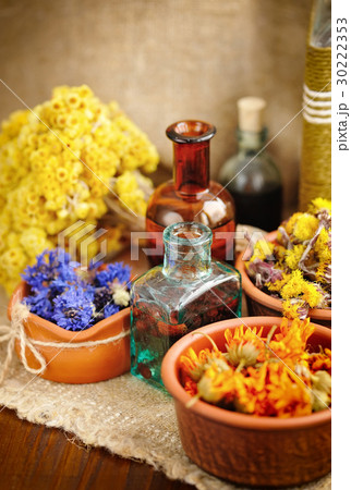 Healing herbs and tinctures in bottles 30222353