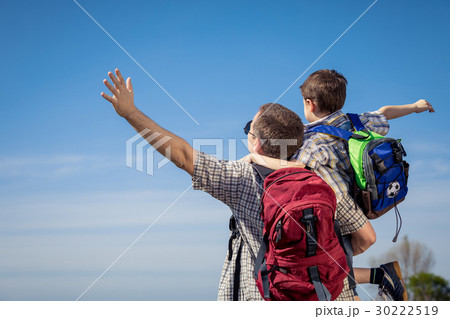 Father and son walking on the road at the day time. 30222519