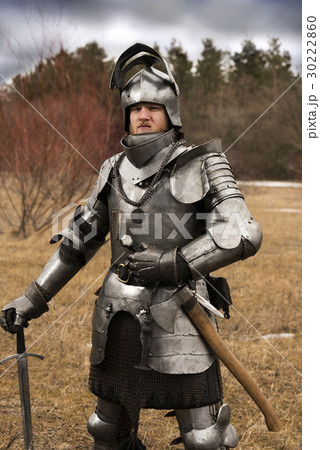 Knight in armour after battle on forest background Knight in armour after battle on forest background 30222860