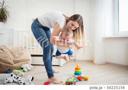Mother playing with her baby boy at living room Mother playing with her baby boy at living room 30225156