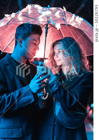 Portrait of a guy and a girl under an umbrella 30226793