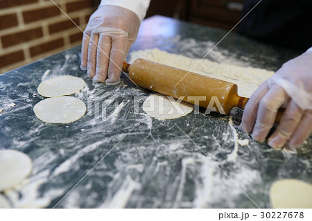 Male chef uses ingredients for preparing flour Male chef uses ingredients for preparing flour 30227678