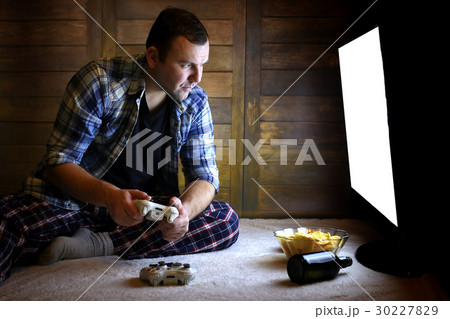 man playing on a console on the joystick man playing on a console on the joystick 30227829