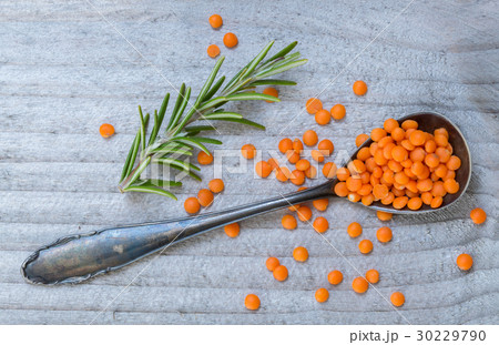 Red lentils and rosemary on a spoon macro Red lentils and rosemary on a spoon macro 30229790