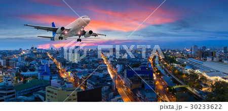 Airplane take off over the panorama city twilight Airplane take off over the panorama city twilight 30233622