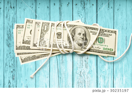 Dollar banknotes wrapped with white rope Dollar banknotes wrapped with white rope 30235197