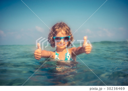 Happy child playing in the sea 30236469
