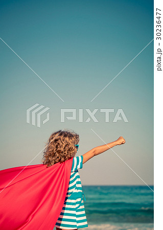 Superhero child on the beach. Summer vacation concept 30236477