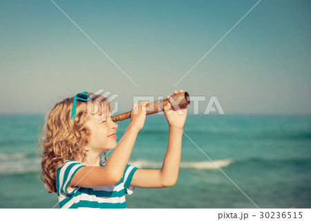 Happy kid playing outdoor against sea and sky 30236515