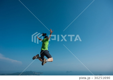 jumping on rocky mountain peak jumping on rocky mountain peak 30251690